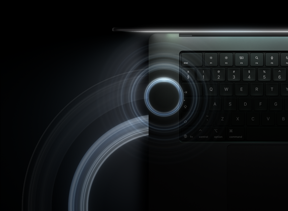 MacBook Pro with PROLED XDR Display, open lid, space black color, keyboard lit by glow from display, circles depicting sonic waves emanate from top and left side of laptop body
