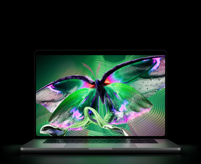 MacBook Pro with PROLED XDR Display, open lid, silver color, display shows detailed, high-contrast image with vivid colors, screen illuminates keyboard